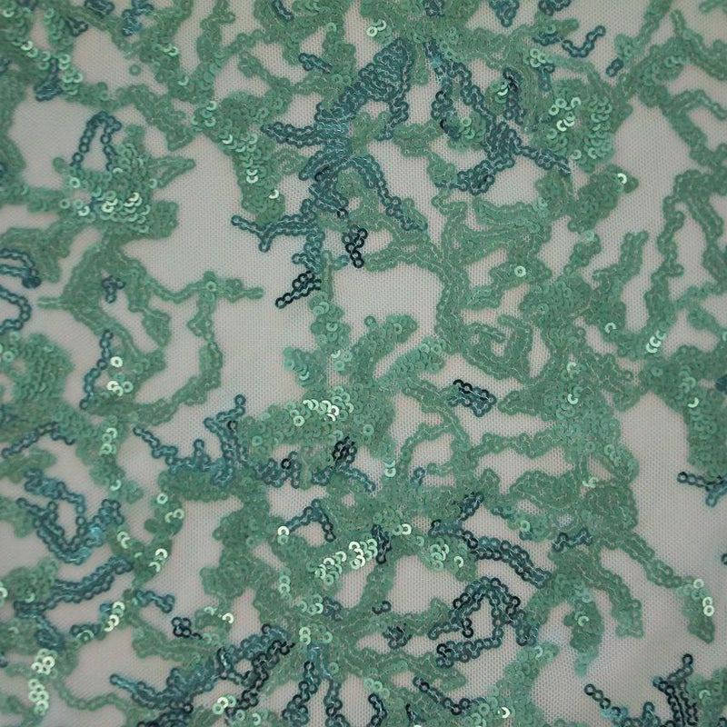 A flat sample of corla reef stretch mesh sequin in the color green.