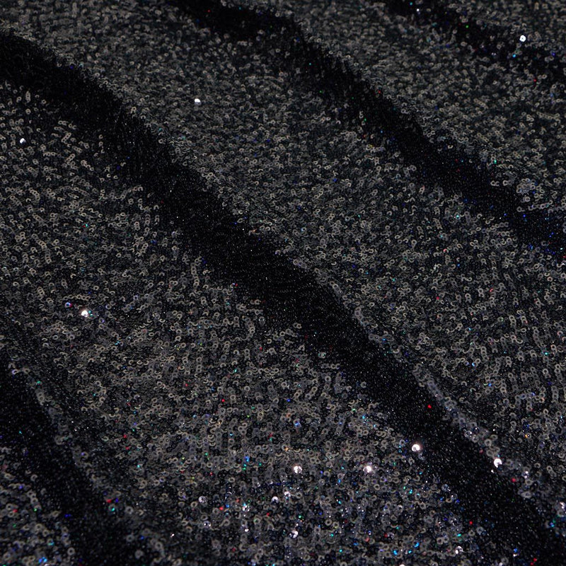 A panel of Cosmic GLOW spandex sequin in black available at Blue Moon Fabrics.