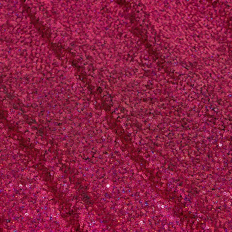 A panel of Cosmic GLOW spandex sequin in raspberry and black available at Blue Moon Fabrics.