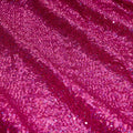 A panel of Cosmic GLOW spandex sequin in fuchsia available at Blue Moon Fabrics.