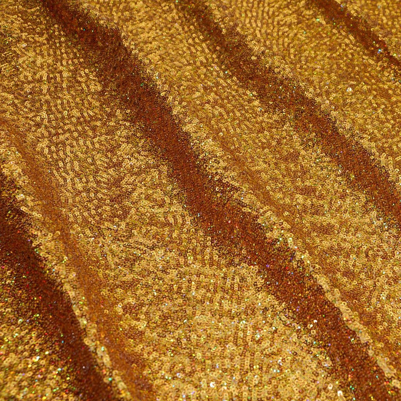 A panel of Cosmic GLOW spandex sequin in gold available at Blue Moon Fabrics.