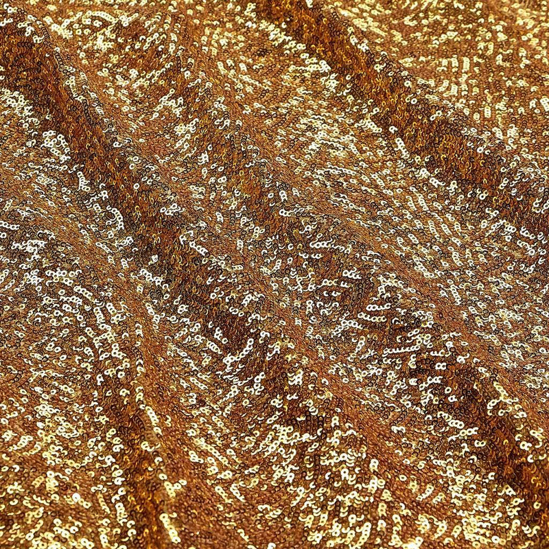 A flat sample of cosmic spandex sequin in the color gold available at blue moon fabrics.