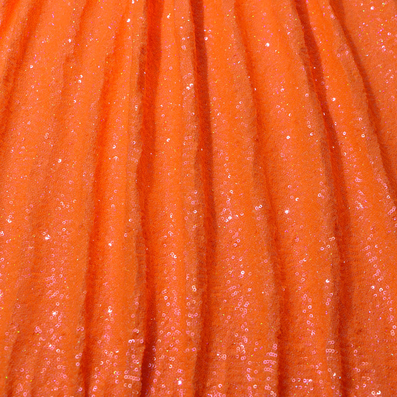 A panel of Cosmic GLOW spandex sequin in Neon Orange available at Blue Moon Fabrics.