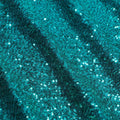 A flat sample of cosmic spandex sequin in the color teal available at blue moon fabrics.