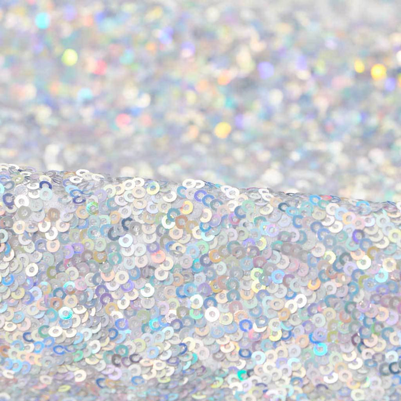 A folded sample of cosmic x spandex sequin in the color white-silver available at blue moon fabrics.