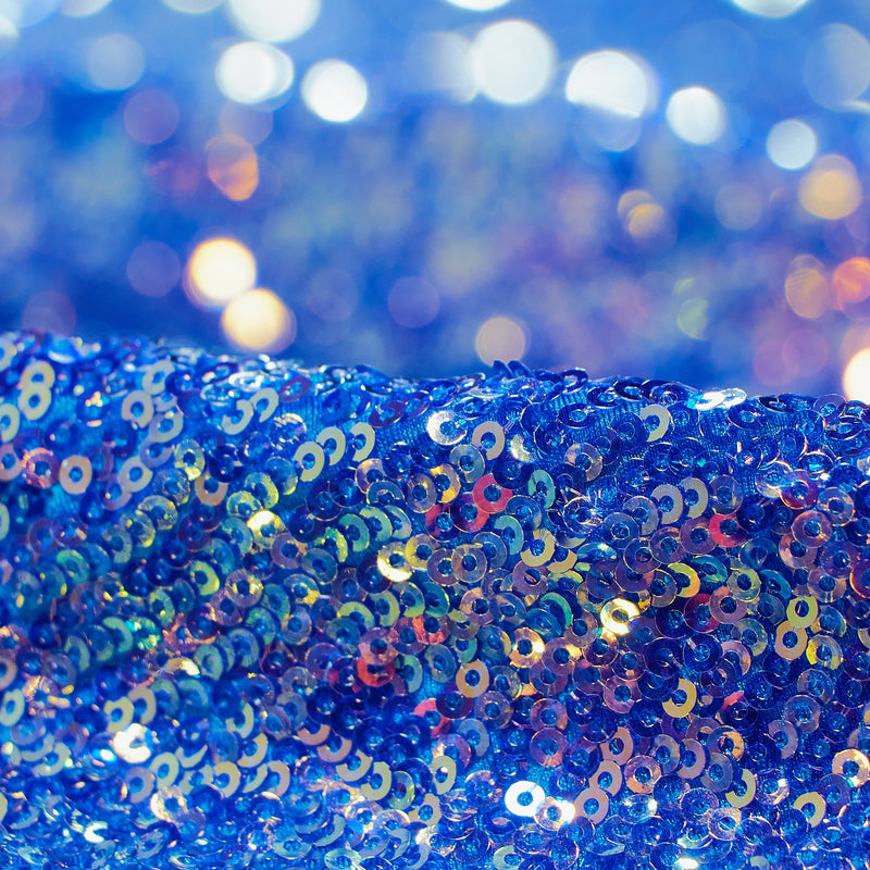 A folded sample of cosmic x spandex sequin in the color azul available at blue moon fabrics.