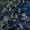 A flat sample of cottage garden stretch lace sequin in the color navy available at blue moon fabrics.