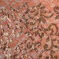A flat sample of cottage garden stretch lace sequin in the color coral available at blue moon fabrics.