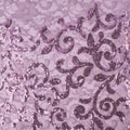 A flat sample of cottage garden stretch lace sequin in the color lilac available at blue moon fabrics.
