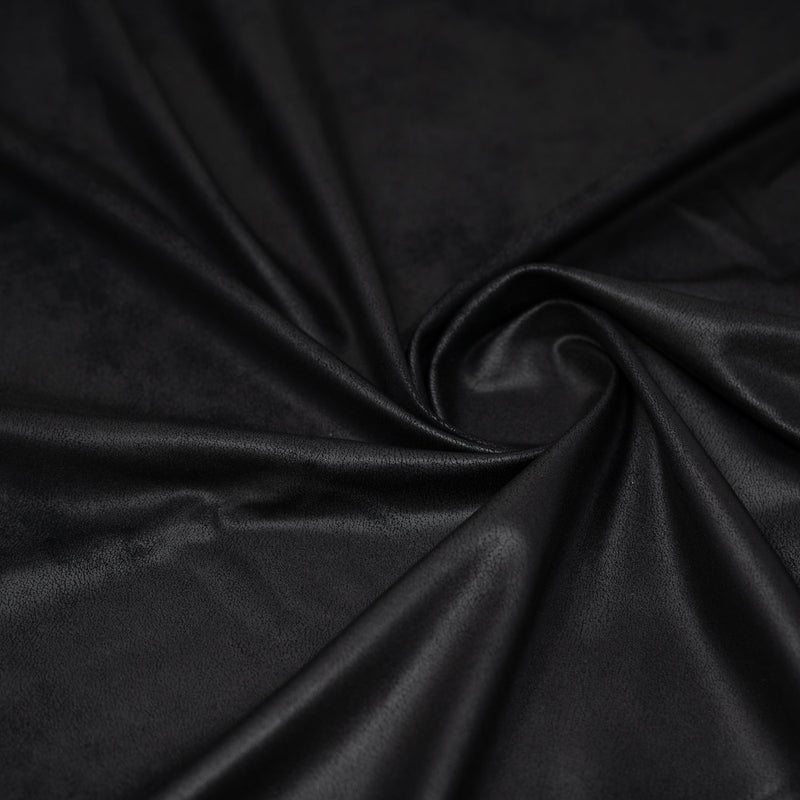 A swirled piece of Cowboy Faux Leather Foil Printed Spandex in the color Black
