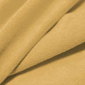 A folded piece of Cozy Polyester Spandex Terry Cloth in the color almond.