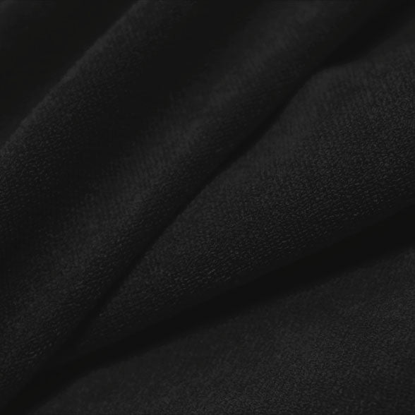 A folded piece of Cozy Polyester Spandex Terry Cloth in the color black