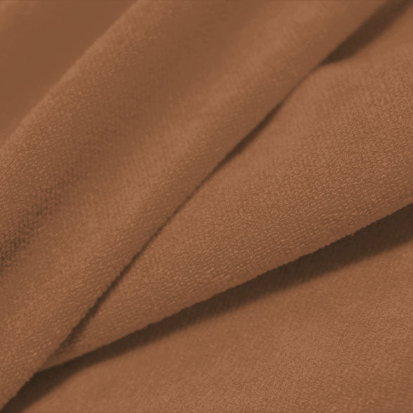 A folded piece of Cozy Polyester Spandex Terry Cloth in the color fawn.