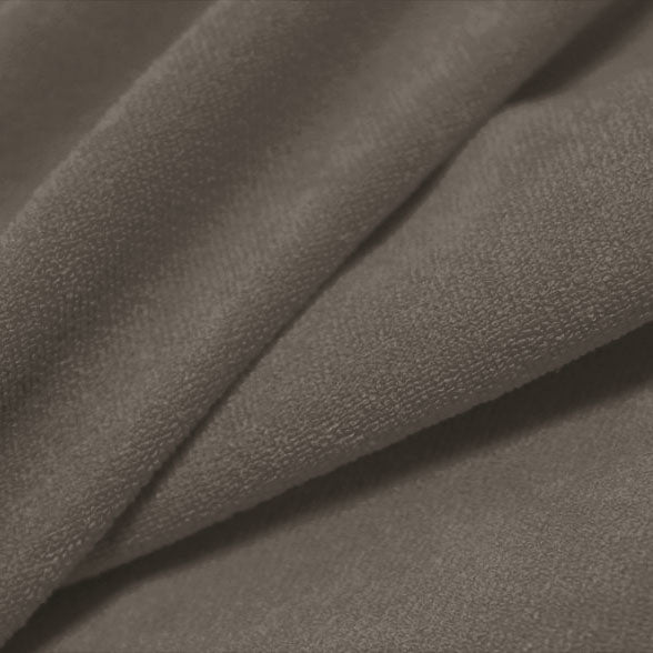 A folded piece of Cozy Polyester Spandex Terry Cloth in the color fossil.