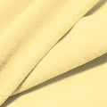 A folded piece of Cozy Polyester Spandex Terry Cloth in the color ivory.