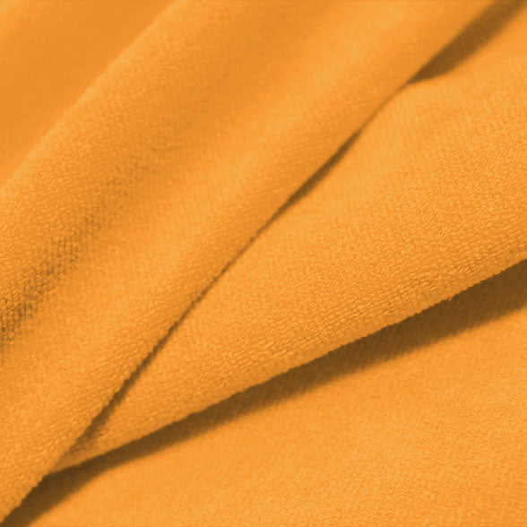 A folded piece of Cozy Polyester Spandex Terry Cloth in the color orange sherbert.