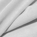 A folded piece of Cozy Polyester Spandex Terry Cloth in the color white.