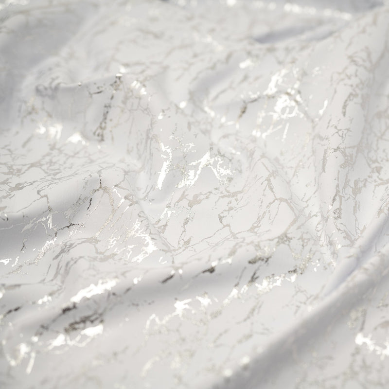 A crumpled piece of Cracked Foil Printed Microflex in the color White-Silver
