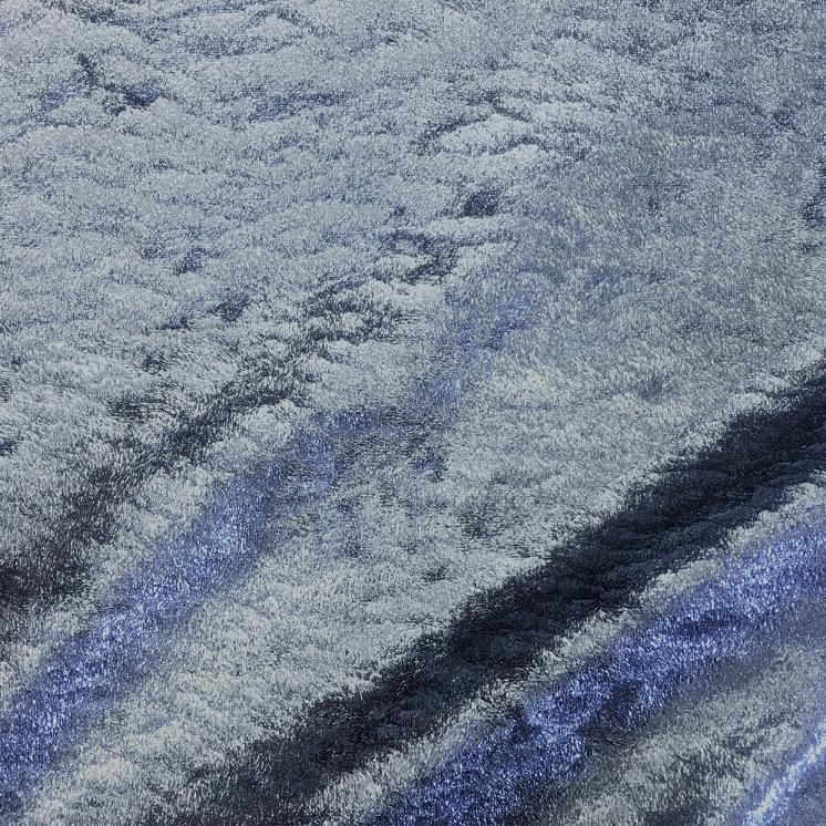 A swirled sample of d-isis foiled stretch velvet in the color cobalt blue.