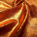 A swirled sample of d-isis foiled stretch velvet in the color rust.
