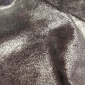 A swirled sample of d-isis foiled stretch velvet in the color silver.