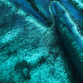 A swirled sample of d-isis foiled stretch velvet in the color teal.