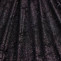 A draped sample of dancing snale glitter stretch mesh in the color black-black.