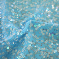 A swirled sample of darling spandex sequin in the color blue.