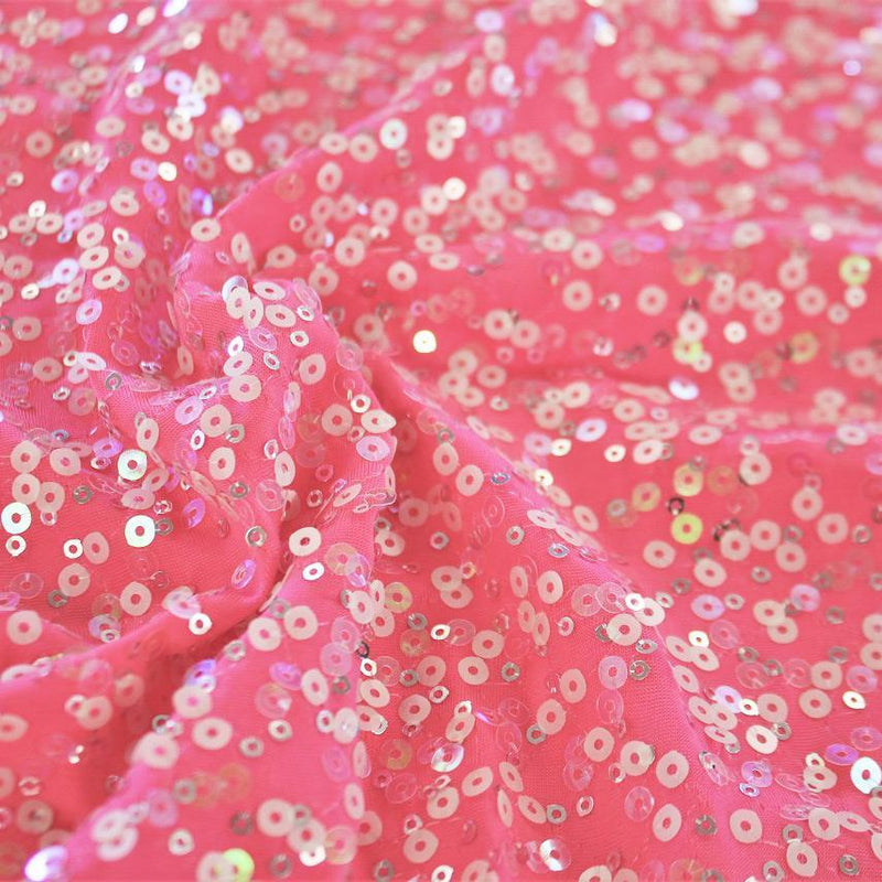 A swirled sample of darling spandex sequin in the color pink.