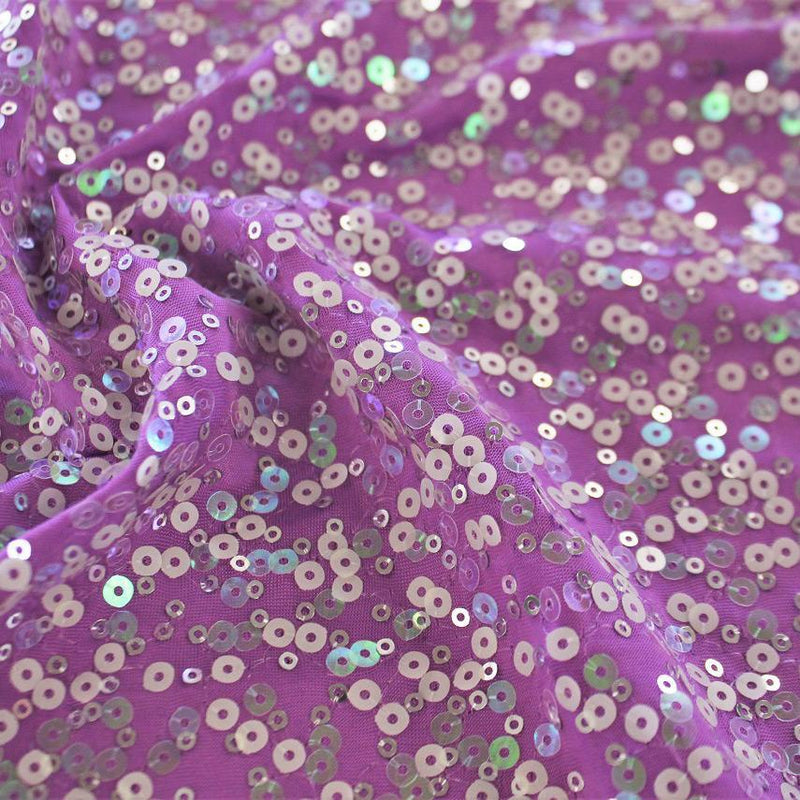A swirled sample of darling spandex sequin in the color purple.