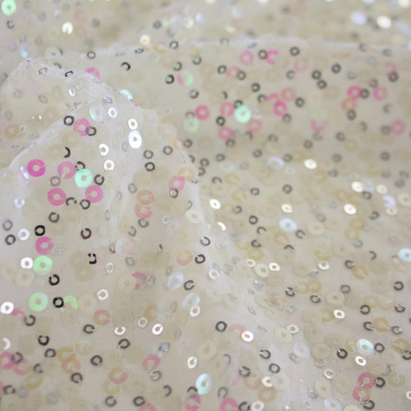 A swirled sample of darling spandex sequin in the color white.