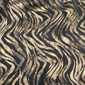 A flat sample of desert zebra foil printed spandex in Black Matte Foil.