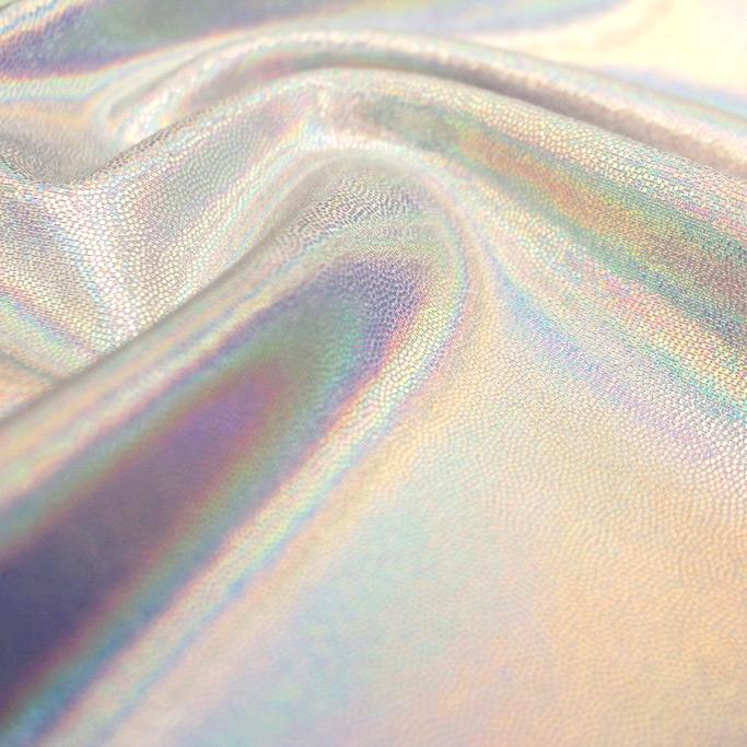 A swirled sample of dizzy foiled spandex in the color white-silver.