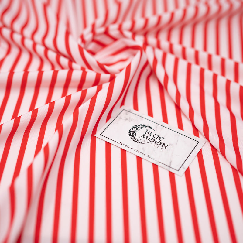 A swirled piece of Double Striped 1/8” Printed Spandex Fabric in Red and White