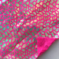 A flat sample of dragon scales holographic spandex sequin in the color hot pink.
