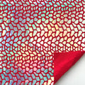 A flat sample of dragon scales holographic spandex sequin in the color red.