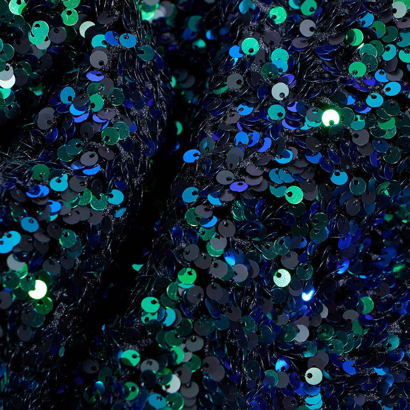 A flat sample of duchess stretch velvet sequin in the color black-blue-green.