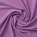 A swirled sample of EcoTechFlex recycled polyester spandex in the color Amethyst Orchid