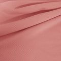 A draped sample of double ribbed spandex in the color blush.