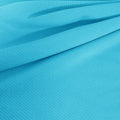 A draped sample of double ribbed spandex in the color celeste blue.