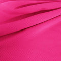A draped sample of double ribbed spandex in the color fuchsia.