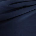 A draped sample of double ribbed spandex in the color marine navy.