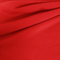 A draped sample of double ribbed spandex in the color red.