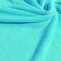 A swirled piece of crinkle polyester spandex jacquard fabric in the color celeste.
