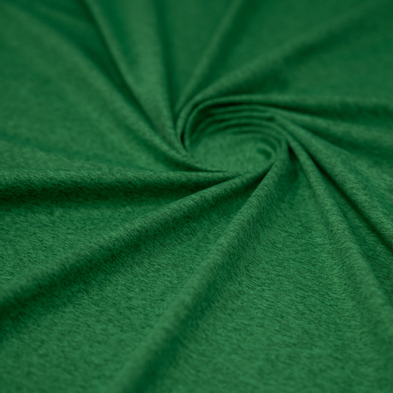 A swirled sample of EcoDelish Double Peached Melange recycled polyester spandex fabric in the color Botanical Green.