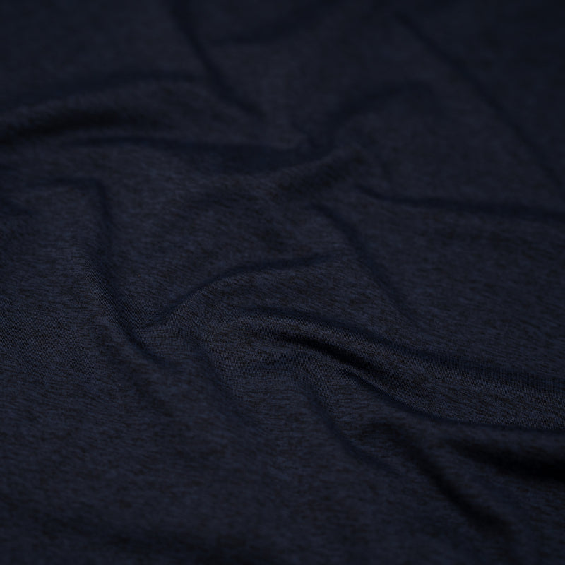 A detailed shot of EcoDelish Double Peached Melange recycled polyester spandex fabric in the color New Midnight..