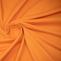 A swirled sample of EcoTechFlex recycled polyester spandex in the color mango.