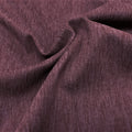 A swirled sample of ecodelish double peached heather recycled polyester spandex fabric in the color fig.