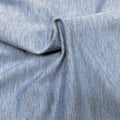 A swirled sample of ecodelish double peached heather recycled polyester spandex fabric in the color steel blue.