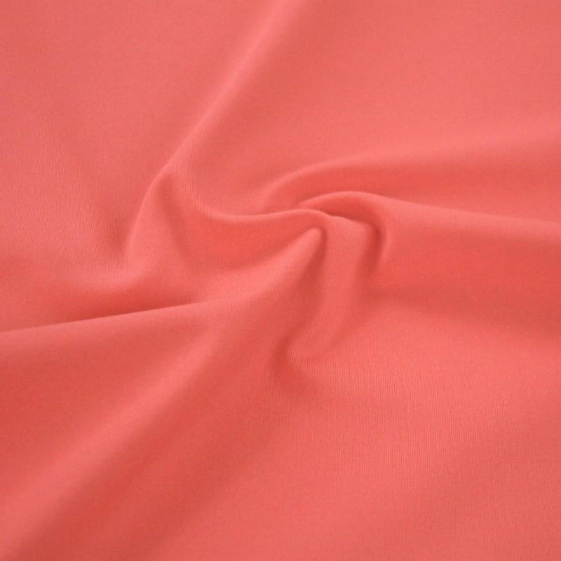 A swirled sample of ecotechflex recycled polyester spandex in the color watermelon.